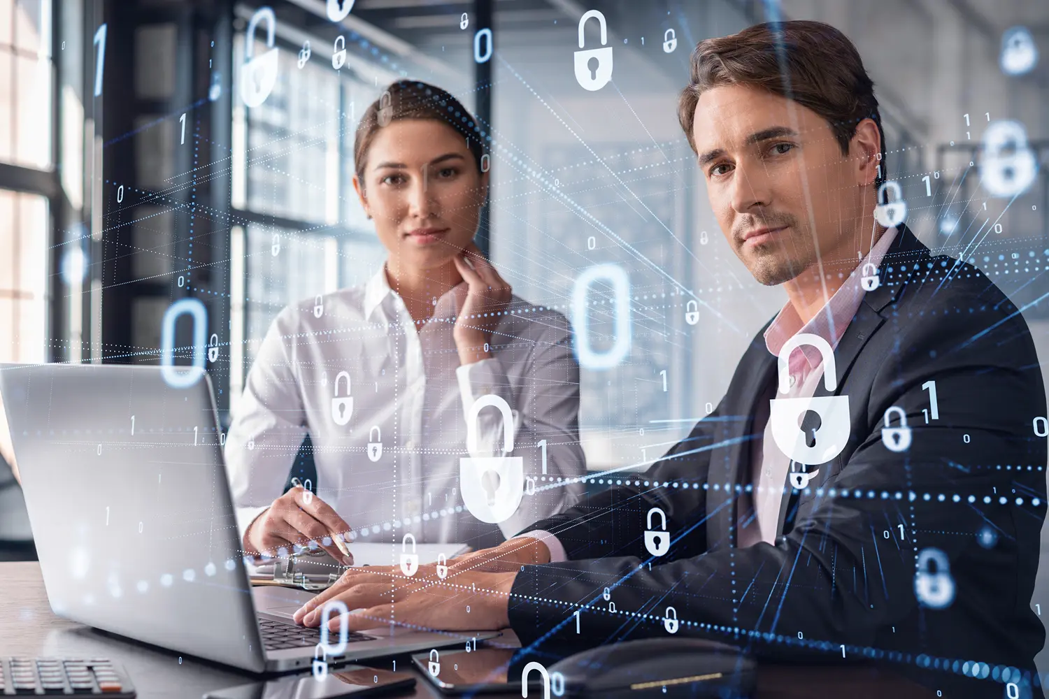 Business professionals at a laptop with binary code and padlock icons overlayed to depict cybersecurity.